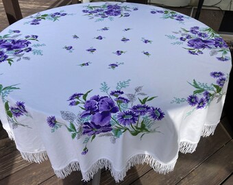 Circular Vintage tablecloth made by Sun Glo. Purple Iris's, Daises, Carnations and assorted Floral with tassels. WOW!