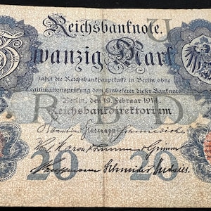 May include: A vintage German Reichsbanknote, featuring ornate blue and red decorative elements. The note displays the text "Reichsbanknote" and "zwanzig Mark" along with the date "19. Februar 1914". The number "20" is prominently displayed.