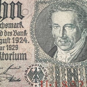 May include: Detailed image of an old German banknote. The note displays a portrait within a circular border, complex designs, and German script. The denomination and date are clear, alongside an eagle emblem.