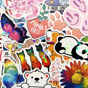 May include: Assortment of colorful stickers featuring various designs, including a butterfly, a panda, a flower, a turtle, and a dog. The stickers have a variety of text, including "Family First", "I Need Space", and "Live Life Happy".