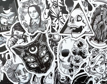 May include: A collection of black and white stickers featuring various spooky and gothic designs, including skulls, cats, snakes, and roses. The stickers are perfect for adding a touch of darkness to laptops, water bottles, or journals.