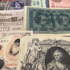 May include: A collection of antique banknotes, displaying diverse designs and portraits. The image includes notes in German and Japanese, with various denominations visible. A glimpse into historical currency.
