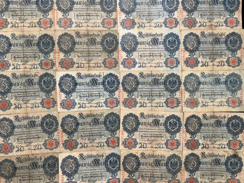 May include: A collection of vintage 20 Mark Reichsbanknote banknotes. The notes feature intricate designs with text, a central emblem, and the number 20. The notes have a beige background with blue, red, and black details.