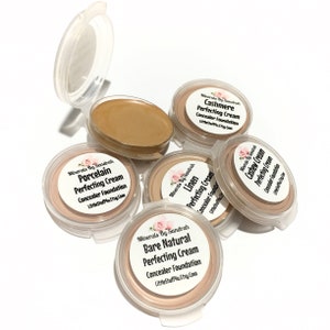 May include: Five small round containers of mineral makeup foundation in shades Porcelain, Cashmere, Linen, Bare Natural, and Cashew Cream. Each container has a label with the name of the shade and the text "Minerals By Sandrah Perfecting Cream Concealer Foundation LittleStufflu.Etsy.Com".
