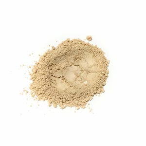 May include: A small, circular pile of fine, light beige powder with a matte texture. The substance is loosely arranged, featuring a slightly uneven surface with tiny granules and a soft, earthy tone, creating a natural, dry, and powdery appearance.