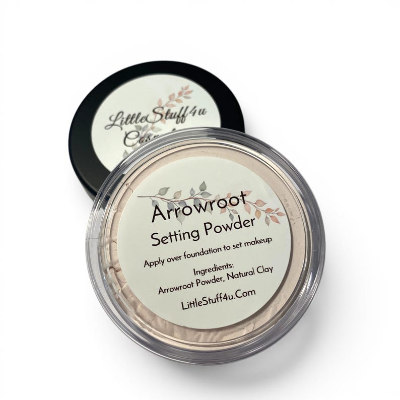 May include: A round container of Arrowroot Setting Powder with a clear lid and a black base. The label features the text Arrowroot Setting Powder, Apply over foundation to set makeup, Ingredients: Arrowroot Powder, Natural Clay, and LittleStuff4u.Com.
