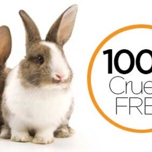 May include: Two rabbits are positioned side by side. One rabbit is solid brown, while the other is white with brown patches. To the right, an orange circular border encloses the black text 100% Cruelty FREE, indicating a standard for animal welfare.