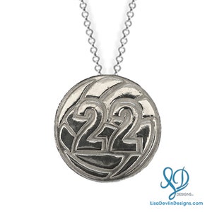 May include: Silver volleyball necklace with the number 22 on a round pendant.