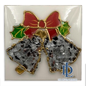 May include: A Christmas-themed artwork featuring two silver bells with gold trim, topped with a red bow and green holly leaves. The artwork is on a white background and includes the text "LISA DEVLIN DESIGNS".