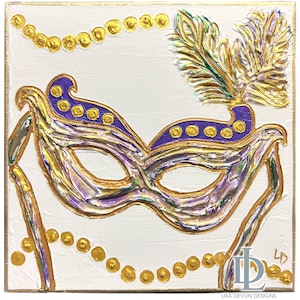 May include: A purple and gold masquerade mask with a feather on top. The mask is painted on a white canvas with gold beads around the edges.