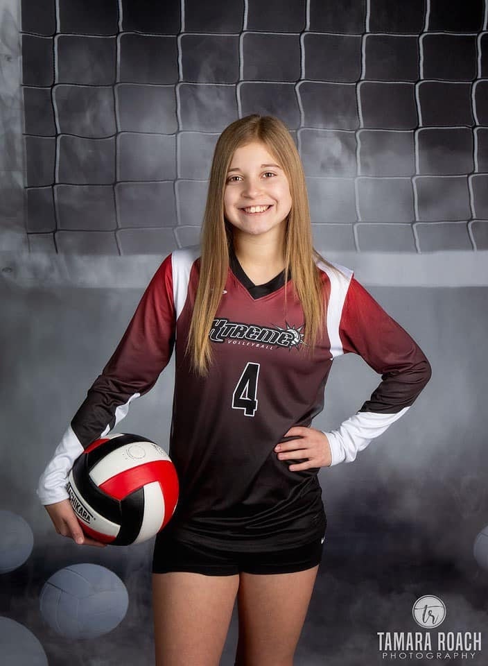 Young Volleyball player woman posing with a ball isolated on a dark  background Stock Photo - Alamy