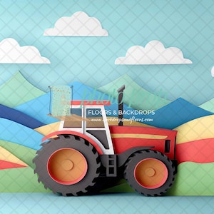 Puede incluir: Un tractor de juguete rojo con una llanta negra y una cabina amarilla y roja, conduciendo por un paisaje de papel de colinas azules, verdes y amarillas sobre un fondo azul con nubes blancas.