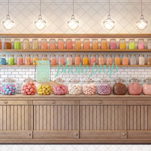 May include: A wooden cabinet displays glass jars filled with colorful candies. Shelves above hold more jars of sweets. The background features a white tile wall and hanging pendant lights, creating a vintage candy shop aesthetic.