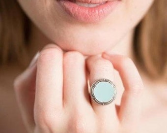 Ring with light blue button