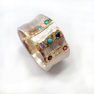 Wide concave silver ring, three gold strips inlaid with selection of gemstones, textured silver base, Hoshen (priestly breastplate) design