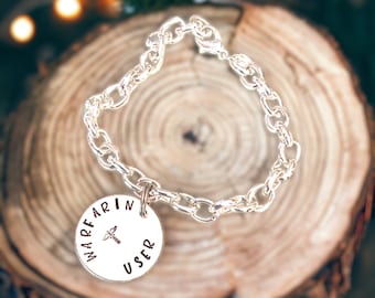 Warfarin user charm bracelet, silver plated chain, hand stamped with caduceus in the middle, 8 inches long