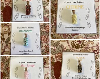 Tiny bottles of crystals mounted on a card for gifting,amethyst,tigers eye, quartz, rose quartz, citrine, garnet,fluorite, obsidian,