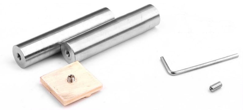 May include: Two cylindrical silver-toned metal rods with threaded ends, a square light-colored wooden base with a central metal screw, a small L-shaped hex key, and a single small threaded metal screw component for assembly and hardware use.