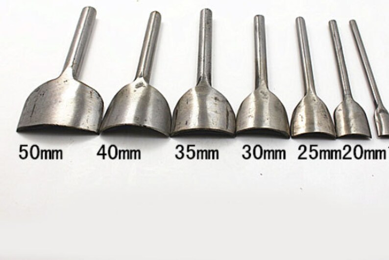 May include: Set of 8 leather punch tools with different sizes: 50mm, 40mm, 35mm, 30mm, 25mm, 20mm, 15mm, and 10mm. The tools are made of metal and have a rounded edge.