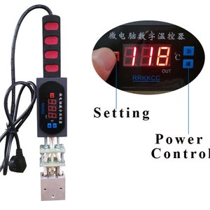 May include: A black digital temperature control device with a red display and a black handle. The device has a power control button and a setting button. The display shows the temperature in degrees Celsius.