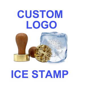 May include: A gold ice stamp with a tree design, with the words "CUSTOM LOGO" and "ICE STAMP" in blue text. The stamp is on a white background.