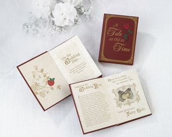 Puede incluir: Un libro rojo con bordes dorados y el título "A Tale as Old as Time" en la portada. El libro está abierto para revelar una caja de anillos con dos anillos de oro en su interior. El libro tiene un fondo blanco con una rosa roja y el texto "Legend of the Wedding Ring" en el interior.