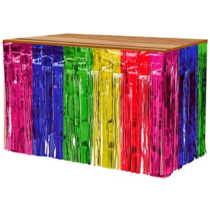 May include: A rainbow-coloured table skirt made of metallic fringe. The skirt is attached to a wooden table top.
