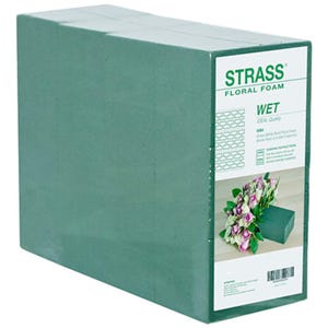 May include: A green brick of wet floral foam by Strass. The foam is ideal for arranging fresh flowers. The packaging shows a bouquet of pink and white roses in a vase.