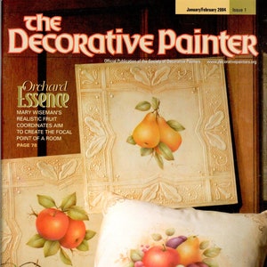 Puede incluir: La portada de la revista "The Decorative Painter" presenta diseños de frutas pintadas. El arte de la portada incluye peras, manzanas, uvas y ciruelas. El título de la revista está en una fuente decorativa, con la fecha y el número de la edición en la parte superior.