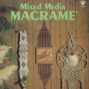 May include: Three macrame wall hangings with different designs. The first is a white and brown hanging with a plant in a small pot. The second is a brown hanging with a square picture of a bird. The third is a brown hanging with a round frame and a small white pot with dried flowers.