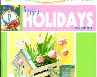 May include: A book titled "happy HOLIDAYS to paint" with a colourful cover featuring a birdhouse with tulips, a pumpkin with the text "HAPPY THANKSGIVING", and a red, white and blue paint can with the text "MADE IN AMERICA".