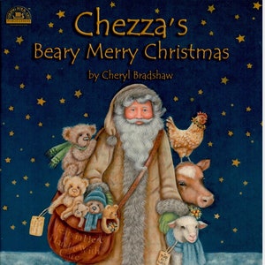 Op de afbeelding: Kinderboekcover van "Chezza's Beary Merry Christmas" door Cheryl Bradshaw. De illustratie toont de Kerstman met een tas vol teddyberen, een kip, een koe en een lam, tegen een blauwe achtergrond met sterren.