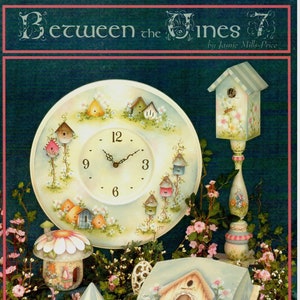 May include: A collection of hand-painted wooden birdhouses and other home decor items. The items are painted in a whimsical style with flowers, birds, and other nature-inspired details. The title "Between the Vines" is visible at the top of the image.