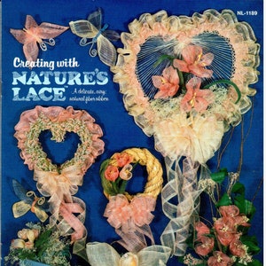 May include: A book cover with the title "Creating with Nature's Lace" and a subtitle "A delicate, airy, natural fiber ribbon". The cover features a variety of handmade crafts made with a delicate, airy, natural fiber ribbon, including wreaths, hearts, and angels.