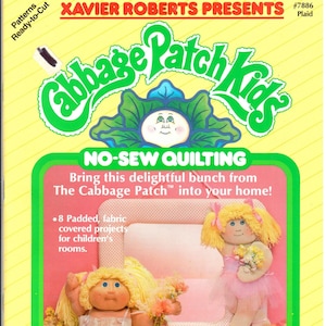 May include: A Cabbage Patch Kids No-Sew Quilting pattern featuring two dolls dressed in pink ballerina outfits. The pattern includes instructions for making a Bitsy Ballerina Mirror. The pattern is from Xavier Roberts Presents and is number 7886 Plaid.