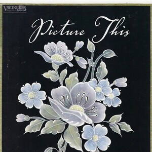 May include: A floral illustration on a black background. The image features a bouquet of light blue and lavender flowers with green leaves. The text "Picture This" and "by Arlene Linton" are written in white script.