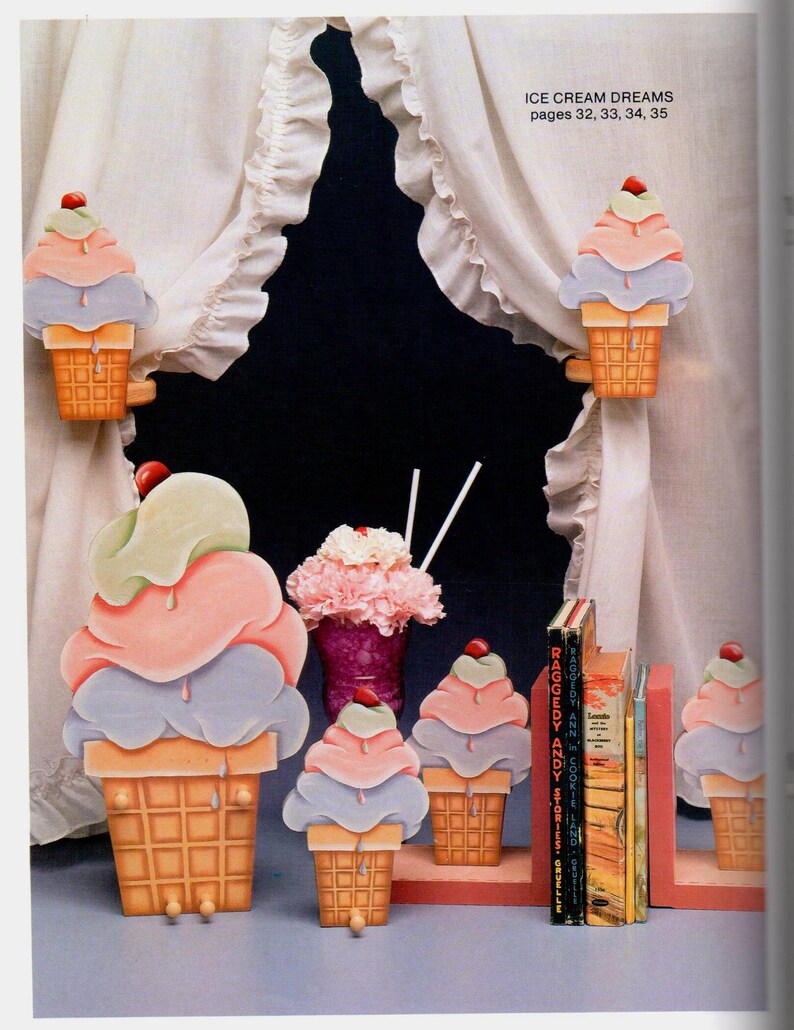 May include: Wooden ice cream cone decorations in various sizes, with pastel scoops and a cherry on top. The cones are brown, and the scoops are pink, blue, and green. The text "ICE CREAM DREAMS" is visible.