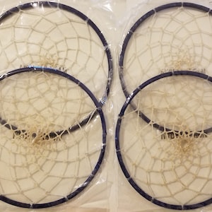 May include: Four white dreamcatchers with blue hoops, packaged in clear plastic bags.