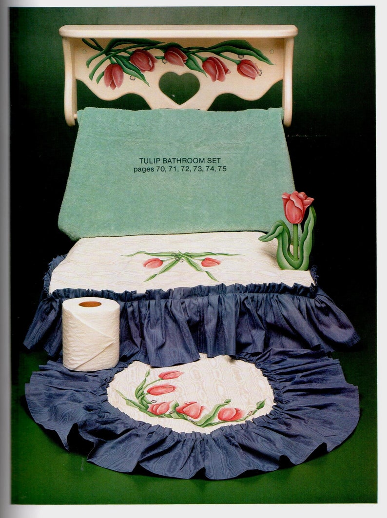 May include: A bathroom set with a tulip theme. The set includes a shelf, a towel, a toilet seat cover, and a rug, all decorated with red tulip designs. The text "TULIP BATHROOM SET" is visible. The set has a blue and white color scheme.