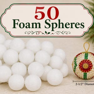 May include: A collection of 50 white foam spheres, each measuring 2-1/2 inches in diameter. Next to the pile is a single finished decorative ornament featuring a red, green, and gold beaded pattern with a gold hanging loop at the top.