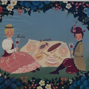 May include: A whimsical painting depicts two figures enjoying a picnic. The scene includes a table with food and wine, surrounded by a floral border of strawberries, grapes, and flowers. The words "le vin", "le poisson", "le fromage", "le pain", and "le gateau" are written on the table.