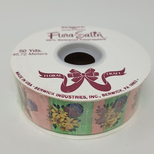 May include: A roll of 50 yards (45.72 meters) of floral craft ribbon with a pink, green, and white striped pattern and a floral design. The ribbon is made by Berwick Industries, Inc. in Berwick, PA 18603.