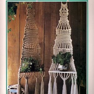 May include: Two macrame wall shelves with wooden shelves and tassels. The shelves are decorated with plants. The title "Half & Half" is at the top of the image.
