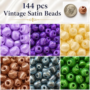 May include: A collection of 144 vintage satin beads in six distinct colors including light purple, dark purple, cream, copper, dark gray, and green. A US dime is shown next to a single copper bead for scale, with the text 144 pcs Vintage Satin Beads.
