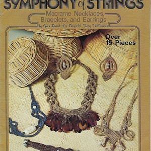 May include: A book titled "The Second Symphony of Strings" with a brown cover and a picture of macrame necklaces, bracelets, and earrings. The book cover also says "Over 15 Pieces" and "Macrame Necklaces, Bracelets, and Earrings by Gwen Baird, Liz Barfield, Tracy Williamson".
