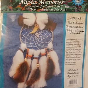 May include: Tan and brown dreamcatcher craft kit with white feathers and beads. The kit makes a 6 inch by 14 inch dreamcatcher. The packaging includes the text "#SW-18 Tan & Brown Dreamcatcher Web is already Complete".
