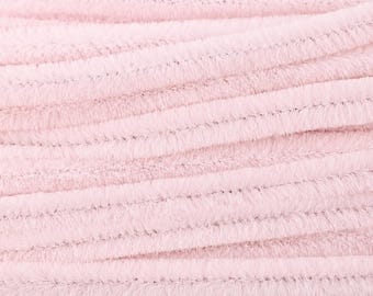 Puede incluir: Una colección de limpiapipas de color rosa claro dispuestos en filas paralelas. Cada tallo para manualidades presenta una textura suave y difusa con un núcleo de alambre flexible visible a través de las densas fibras sintéticas rosa pálido.