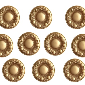 May include: Ten gold-colored metal buttons with a raised, circular design in the center and a decorative border. The buttons have a slightly textured surface.