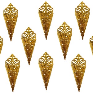 May include: A collection of ornate, gold-colored finger armor, each with a pointed, cone-like shape. The decorative pieces feature intricate floral and scrollwork patterns, creating a vintage or fantasy aesthetic. The background is plain white.