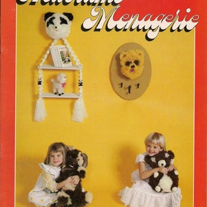 May include: A book cover with the title "Macrame Menagerie" in a red and yellow color scheme. The cover features a panda, a lamb, and a bear, all made with macrame. The book includes 11 projects.